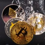 FILE PHOTO: Souvenir tokens representing cryptocurrency networks Bitcoin, Ethereum, Dogecoin and Ripple plunge into water